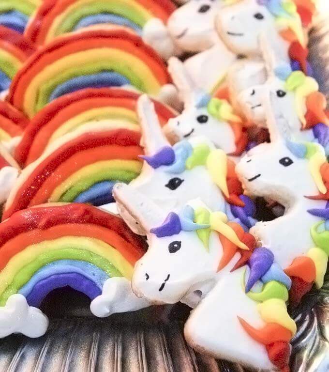 Rainbows and rainbow unicorn sugar cookies decorated with royal icing.