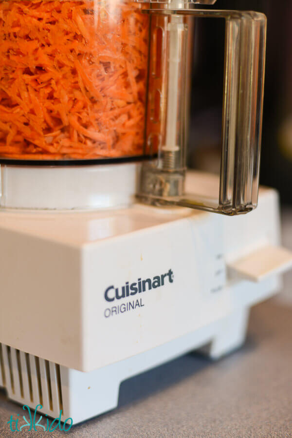 Carrots being grated for the best carrot cake recipe.