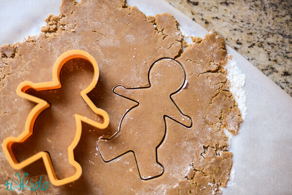 Gingerbread men being cut out of gingerbread dough