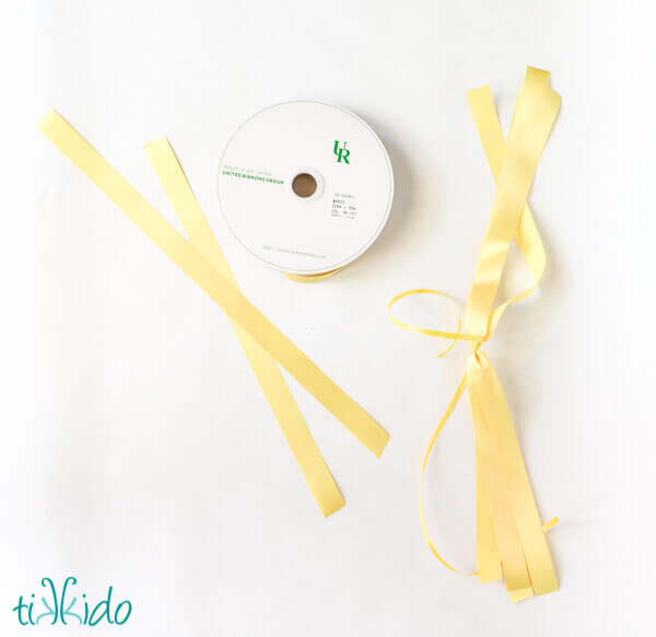 Yellow satin floral ribbon cut into strips and gathered to make a balloon tassel.