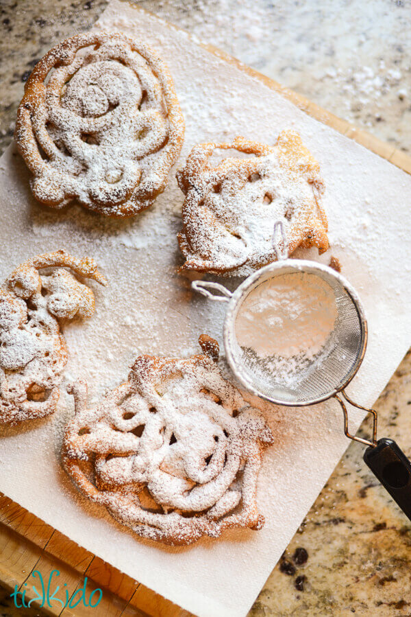 Mini funnel cakes dusted with powdered sugar.