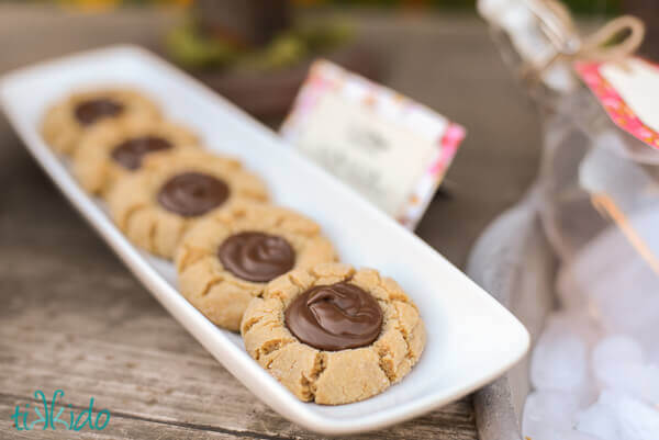 Peanut Butter Nutella Thumbprint Cookies on a white tray.