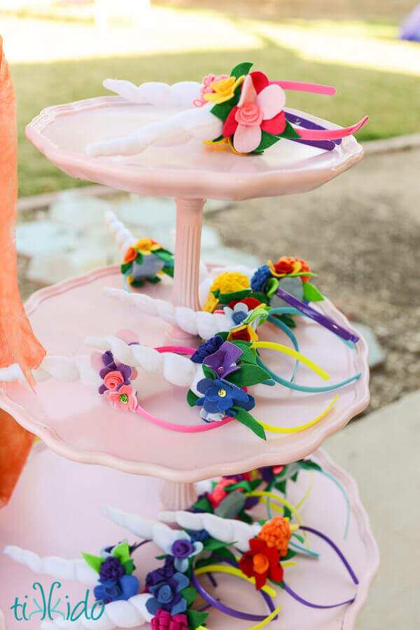 three tiered tray with numerous felt unicorn horn and flower headbands displayed.
