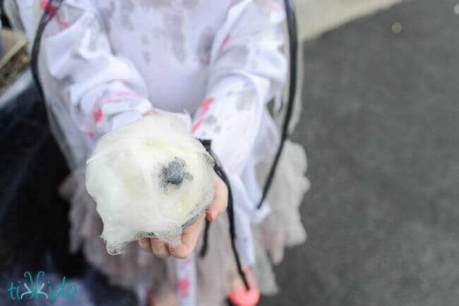 Spiderweb cotton candy cupcake held by a little girl in a zombie costume at the Spider Trunk or Treat.