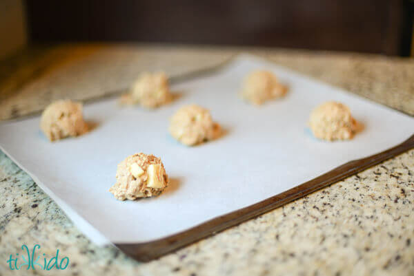 Uncooked caramel apple oatmeal cookies on a cookie sheet.