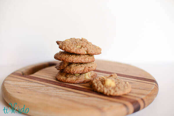 Stack of apple oatmeal cookies on a wooden cutting board