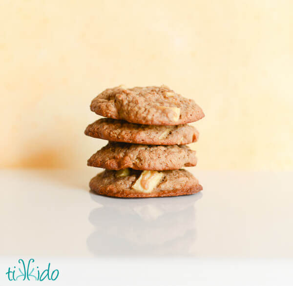 Stack of caramel apple oatmeal cookies on a white surface