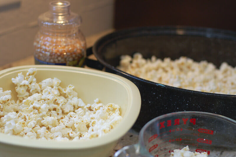 Popped popcorn in roasting pan to make bright colored candied popcorn using kool aid.