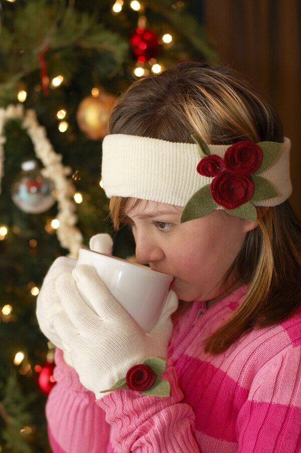 Girl sipping hot chocolate in front of a Christmas tree