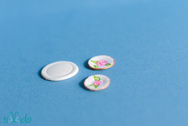 Miniature gum paste plates and saucers on a blue background.