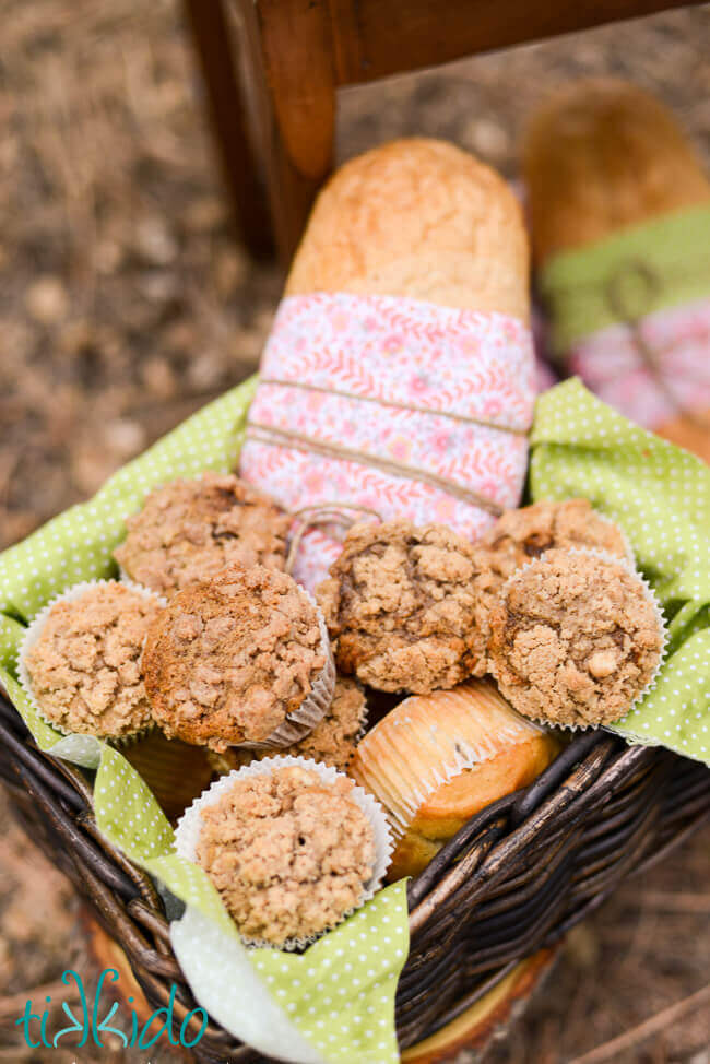 Basket full of applesauce spice muffins with crumb topping.