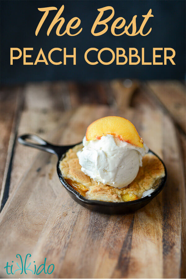 Homemade peach cobbler baked in a cast iron skillet and topped with a scoop of vanilla ice cream.