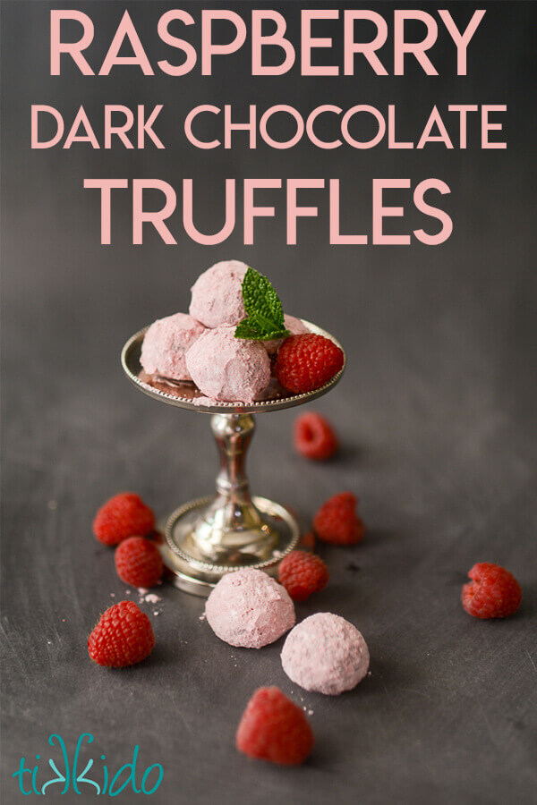 Chocolate Raspberry Truffles on a small silver stand, surrounded by fresh raspberries.