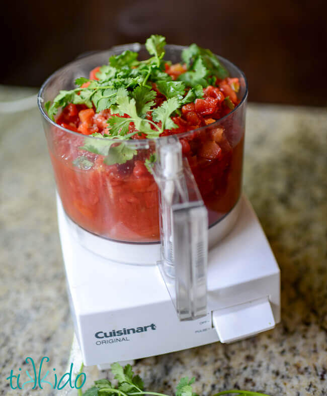 Ingredients for red salsa recipe in a Cuisinart food processor.