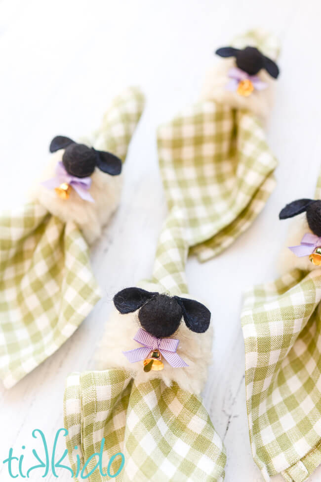 Green gingham napkins with Easter napkin rings that look like sheep.