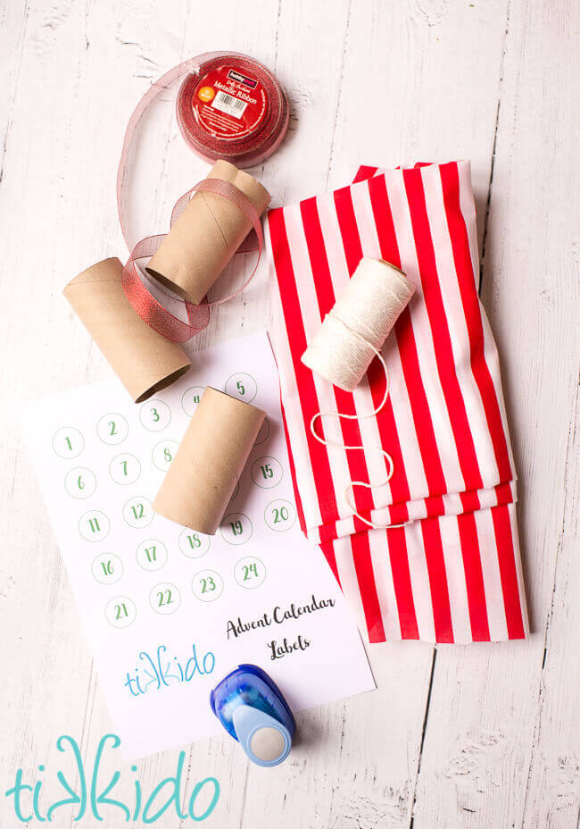 Materials for DIY Advent Calendar garland on a white wooden surface.