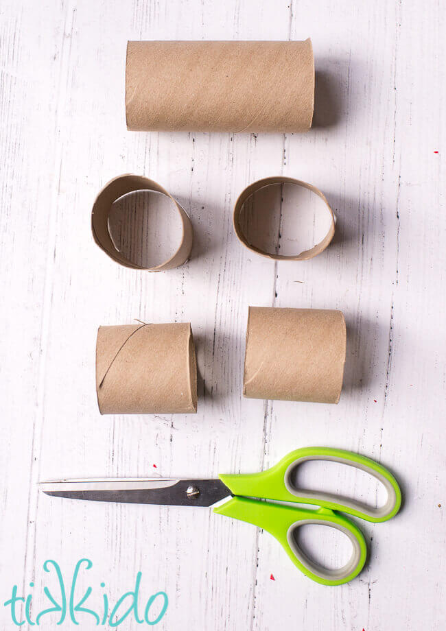 Toilet paper tubes being cut in half to make a DIY Advent Calendar