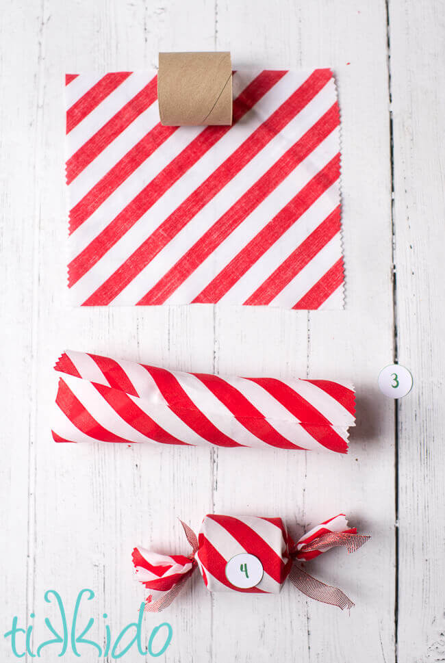 toilet paper tubes being wrapped in red and white fabric to make a DIY Advent Calendar