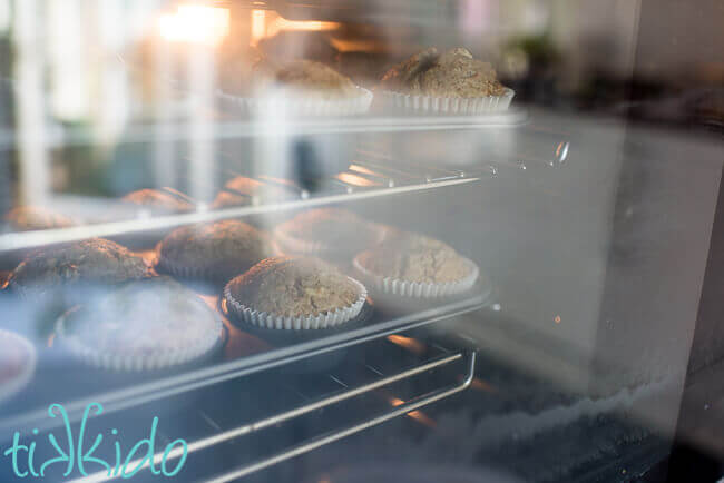 Apple muffins baking in an oven.