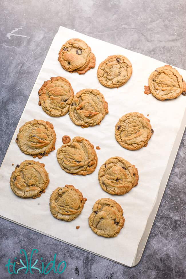 Freshly baked Browned Butter Chocolate Chip Cookies on a parchment lined cookie sheet.