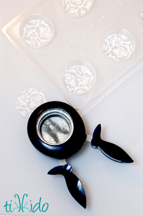 Chocolate transfers cut into 2 inch circles with a punch for fancy chocolate covered oreo molds.