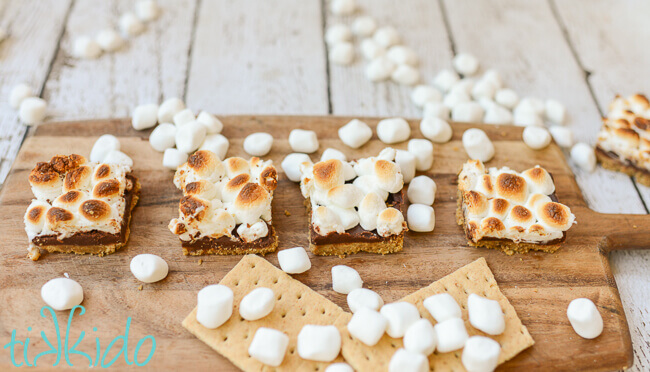 S'mores bar cookies on a wooden cutting board.