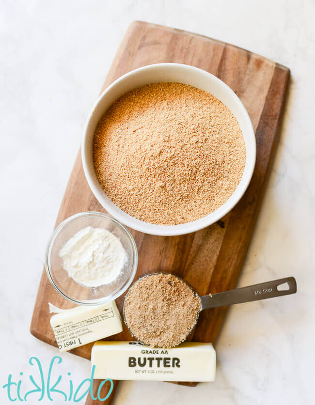 Graham cracker crust ingredients on a wooden cutting board.