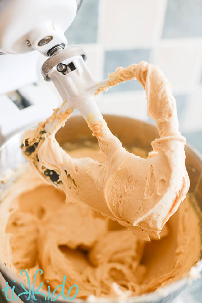 Peanut Butter Frosting being made in a Kitchenaid Mixer.