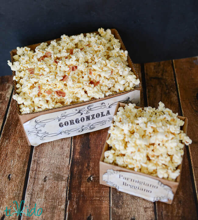 Gorgonzola and Parmigiano Reggiano  popcorn in boxes on a wooden surface.