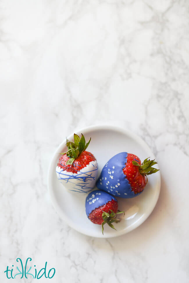 Strawberries dipped in white and blue chocolate melts, sprinkled with silver star sprinkles for the 4th of July