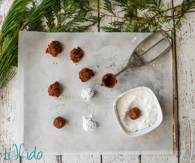 Gluten Free chocolate crinkle cookie dough scooped out on parchment paper