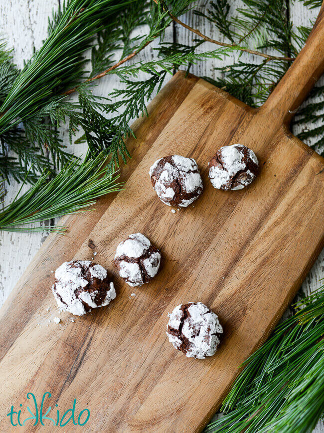Gluten Free chocolate crinkle cookies on a wooden cutting board