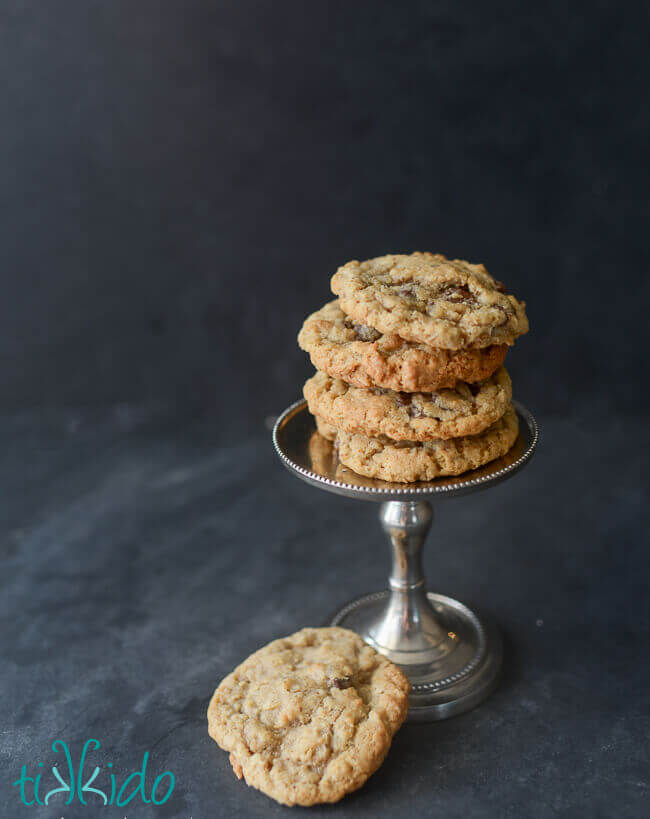 oatmeal chocolate chip cookies stacked on a small silver stand.