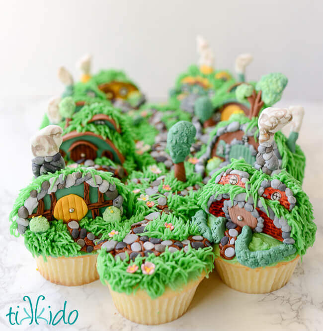 Collection of hobbit hole cupcakes clustered together to form the Shire.