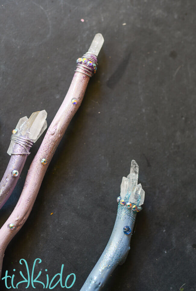 Three pastel, sparkly Luna Lovegood inspired Harry Potter magic wands topped with quartz crystals.