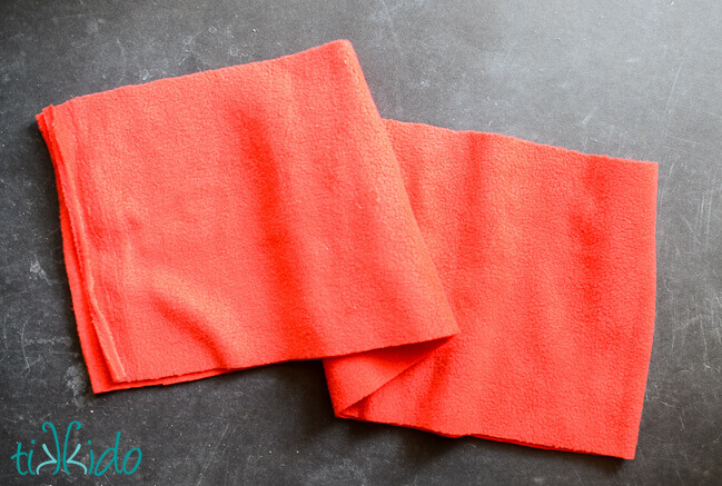 Red fleece cut into a long rectangle to make a no sew fleece scarf for the Mr. Tumnus Costume