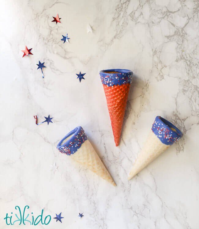 Red, white, and blue ice cream cones with chocolate and sprinkles.