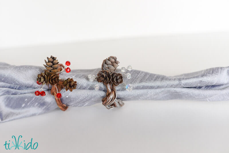 Real pinecone napkin rings made with pine cones, Swarovski crystals, and floral wire.