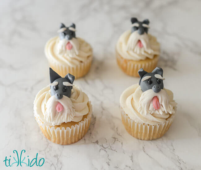 Four cupcakes decorated with gum paste scottie dogs