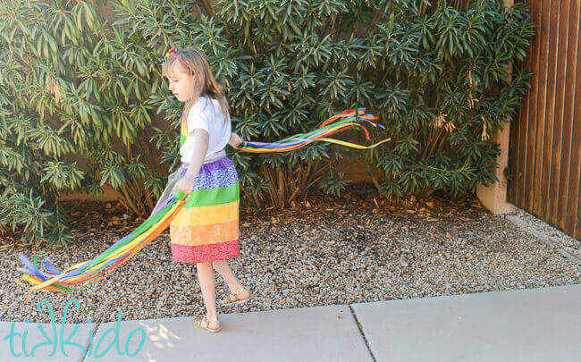 Little girl playing with Rainbow Ribbon Toys.