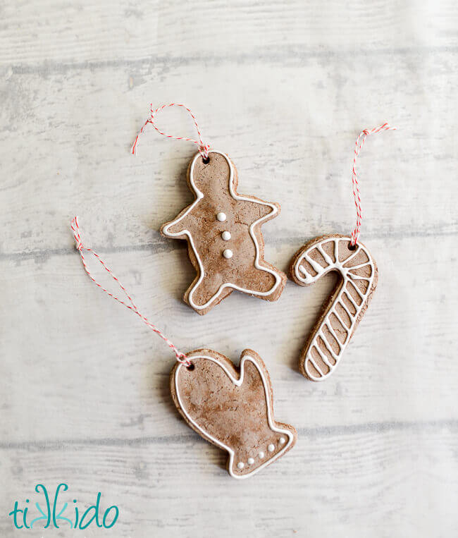 Gingerbread salt dough ornaments for Christmas on a white wooden background.