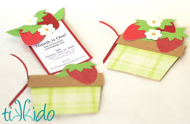 Strawberry Picnic Birthday invitations that look like baskets of strawberries.