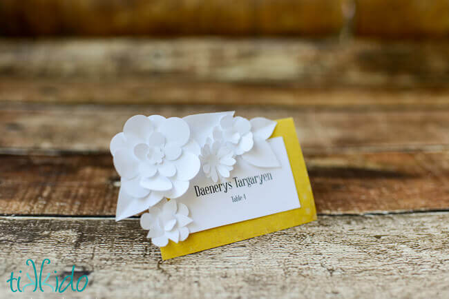 DIY seating card embellished with miniature white paper flowers