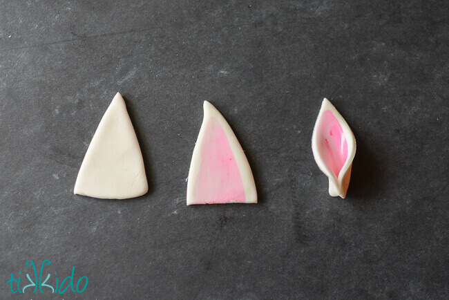 Gum paste unicorn ears tutorial progression, showing the cut shape, the painted cut shape, and the shape pinched into a Unicorn ear shape.