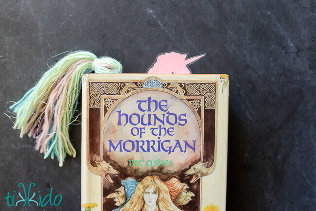 Unicorn bookmark peeking out of the top of The Hounds of the Morrigan book.