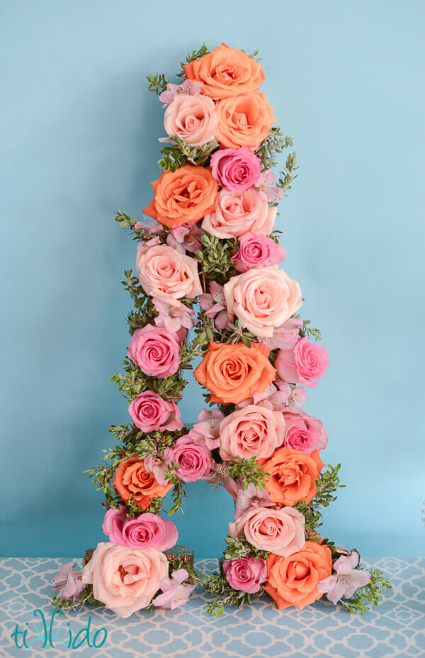 Large A made from fresh roses and greenery at the First Birthday Brunch