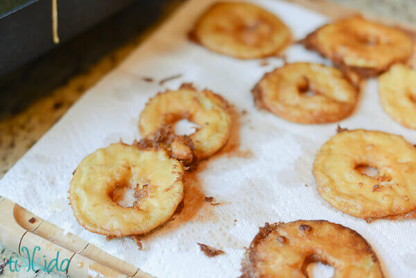 Freshly fried apple fritter rings.