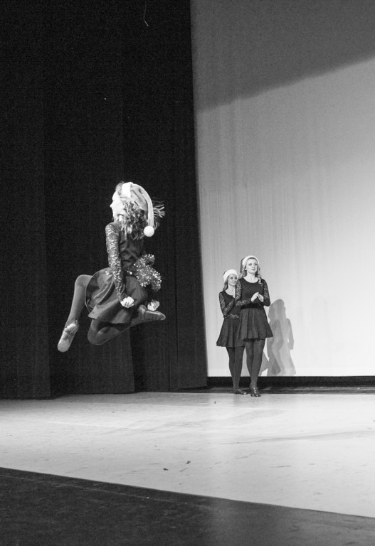 Black and white image of an Irish dancer leaping in mid-air.