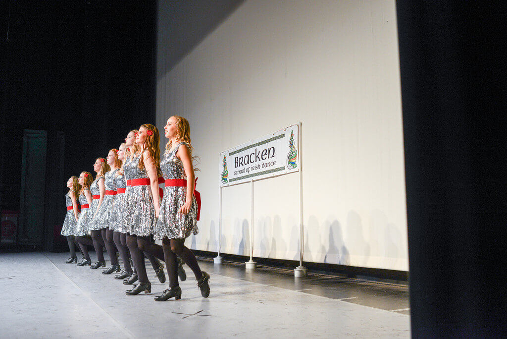Eight girls Irish dancing in a line.