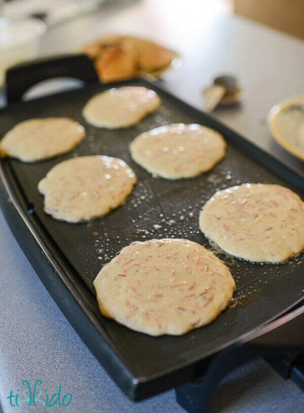 Carrot Cake Pancakes being cooked on an electric griddle.